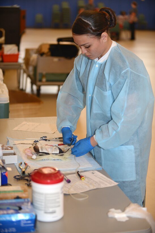 U.S. Navy Seaman Marie Bothwell, Naval Medical Center Portsmouth Corpsman Blood Donor Center hospitalman, prepares blood packets for shipment during a blood drive at Langley Air Force Base, Va., June 2, 2015. The Armed Services Blood Program sends blood to deployed environments weekly. (U.S. Air Force photo by Airman 1st Class Devin Scott Michaels/Released)