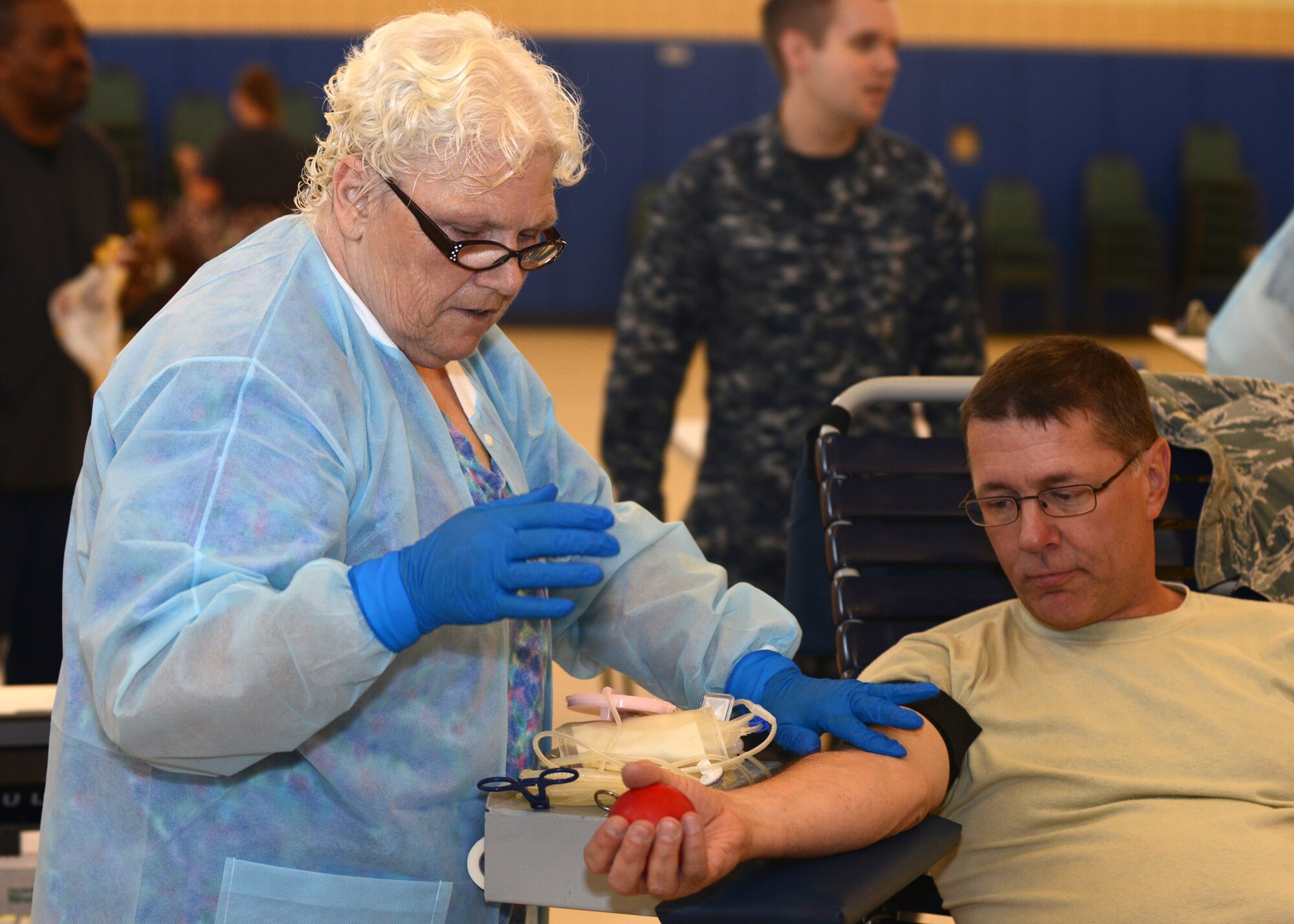 U.S. Air Force Lt. Col. Mark Duff, 633rd Medical Group family health physician, prepares for a staff member to begin drawing blood during a blood drive at Langley Air Force Base, Va., June 2, 2015. As a joint operation, the Armed Services Blood Program has many components working together to collect, process, store, distribute, and transfuse blood worldwide. (U.S. Air Force photo by Airman 1st Class Devin Scott Michaels/Released)