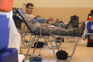 U.S. Air Force Lt. Col. Jimmy Pedany, Air Combat Command Airborne Reconnaissance Operations Branch chief, donates blood during a blood drive at Langley Air Force Base, Va., June 2, 2015. The blood drive was held by the Armed Services Blood Program to provide blood-related supplements to military hospitals worldwide. (U.S. Air Force photo by Airman 1st Class Devin Scott Michaels/Released)