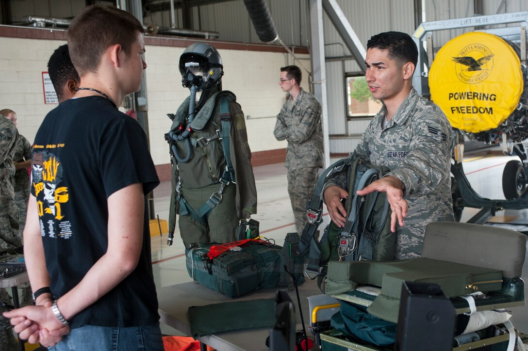 U.S. Air Force Senior Airman Israel Medina, 1st Operations Squadron aircrew flight equipment journeyman, describes uses for different types of parachutes used in both the F-22 Raptor and T-38 Talon aircraft to students from high schools in the Hampton Roads area while on a mission orientation tour at Langley Air Force Base, Va., May 29, 2015. During the tour Service members from across the 1st Fighter Wing gave the students an in-depth look at the many facets that contribute to the wing’s mission. (U.S. Air Force photo by Senior Airman R. Alex Durbin/Released)