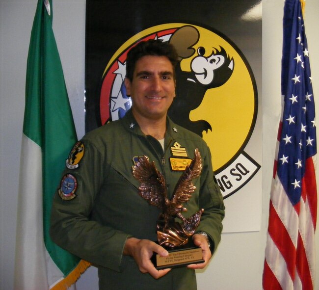 The 90th Flying Training Squadron unit commander, Colonel Alessandro Asaro, proudly holds the Air Education and Training Command annual Top Operations, Flying Training Category Award.  The unit was recognized for the period of Jan 1 – Dec. 31, 2014 for its innovative class redistribution concept which streamlines instructor pilot availability and cuts flight cancellations by 50 percent. (USAF Courtesy Photo)
