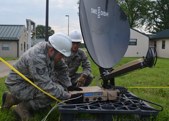 Staff Sgt. Rick Jones, radio frequency transmissions craftsman with the Missouri Air National Guard’s 239th Combat Communications Squadron, left, and Airman 1st Class Nathan Jurado, client systems technician also with the 239th, check their communications equipment while supporting a Missouri Air National Guard training exercise at Camp Clark, near Nevada, Missouri, June 3, 2015.  The 239th was on hand to provide communications support to the while training for their emergency response mission.

(U.S. Air National Guard photo by 2nd Lt. Justin Clark)