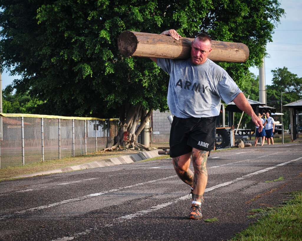 Command Sgt. Maj. Nelson Callahan, Joint Task Force-Bravo Command Sgt. Maj., carries a log around the track at Soto Cano Air Base, Honduras, June 03, 2015. During his year at Soto Cano, CSM Callahan has used his famous “Sgt. Maj. PT” sessions to strengthen JTF-B physically and as a team (U.S. Air Force photo by Capt. Christopher Love). 