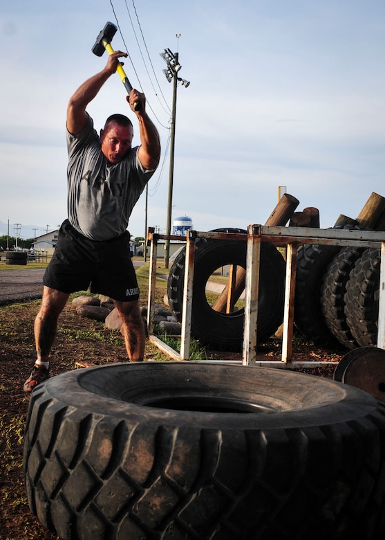 Command Sgt. Maj. Nelson Callahan, Joint Task Force-Bravo Command Sgt. Maj., swings a sledge hammer into a tire for strength training June 03, 2015, at Soto Cano Air Base, Honduras. During his year at Soto Cano, CSM Callahan has used his famous “Sgt. Maj. PT” sessions to strengthen JTF-B physically and as a team (U.S. Air Force photo by Capt. Christopher Love). 
