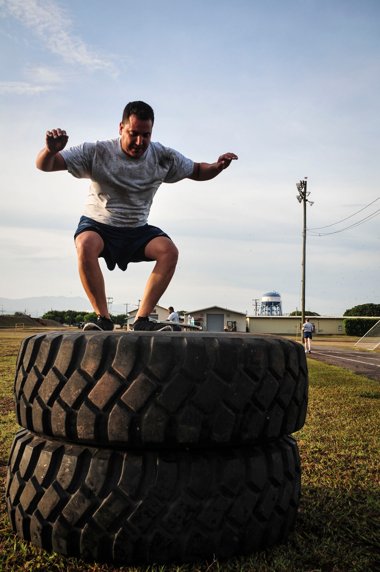 Lt. Col. Mathew Contreras, Joint Task Force-Bravo deputy commanding officer, jumps onto a stack of tires during a specialized physical training session June 03, 2015, at Soto Cano Air Base, Honduras. Known as “Sgt. Maj. PT,” these workouts, led by Command Sgt. Maj. Nelson Callahan, JTF-B Command Sgt. Maj., afford service members the chance to strengthen themselves physically and as a team (U.S. Air Force photo by Capt. Christopher Love).