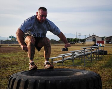 Command Sgt. Maj. Nelson Callahan, Joint Task Force-Bravo Command Sgt. Maj., jumps onto a stack of tires during a physical training session June 03, 2015, at Soto Cano Air Base, Honduras. A dedicated athlete and mentor, CSM Callahan invites others to join him during his specialized physical training session so they can “lead by example…break a sweat…blast [their] core and…build unit cohesion” (U.S. Air Force photo by Capt. Christopher Love). 
