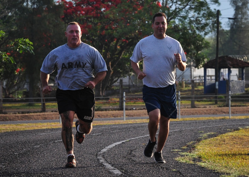 Command Sgt. Maj. Nelson Callahan, Joint Task Force-Bravo Command Sgt. Maj. (left) and Lt. Col. Mathew Contreras, JTF-B deputy commanding officer, run a warm-up lap, prior starting their specialized physical training session June 03, 2015, at Soto Cano Air Base, Honduras. During his year at Soto Cano, CSM Callahan has used his famous “Sgt. Maj. PT” sessions to strengthen JTF-B physically and as a team (U.S. Air Force photo by Capt. Christopher Love). 