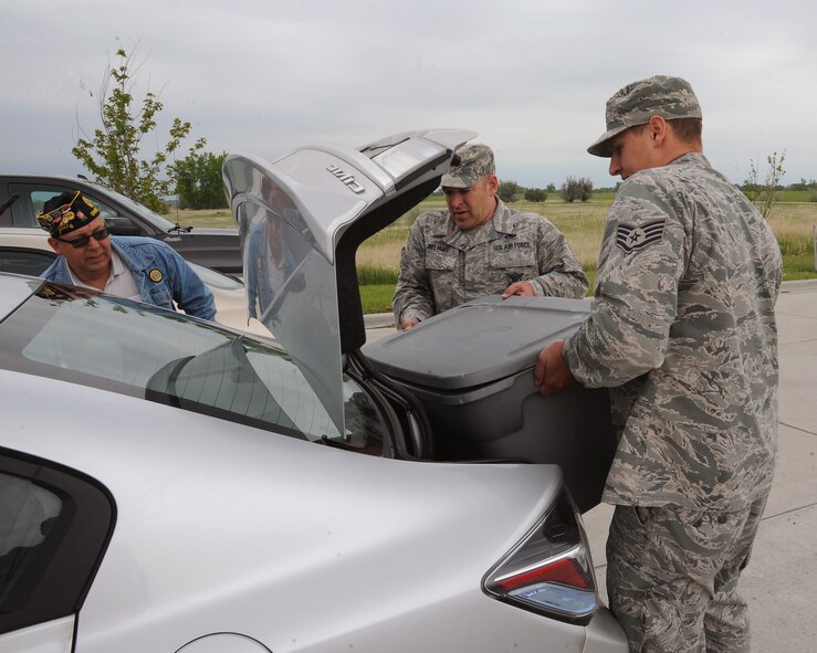 Staff Sgt. Shane Holland, 319th Civil Engineer Squadron fire fighter and Master Sgt. Brian Williams, 319th CES assistant fire chief of operations pack into a car hundreds of soda can pull tabs collected at the 319th CES Fire Department June 2, 2015 on Grand Forks Air Force Base, N.D. All of the tabs collected are used to create donation funds for the Ronald McDonald House in Bismarck, N.D. (U.S. Air Force photo by Senior Airman Zachiah Roberson/released)