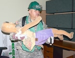 Army Master Sgt. Luis Lopez carries out a mock casualty during a search and rescue exercise May 27 at the U.S. Army Medical Command headquarters, Joint Base San Antonio-Fort Sam Houston.
Photo by Esther Garcia
