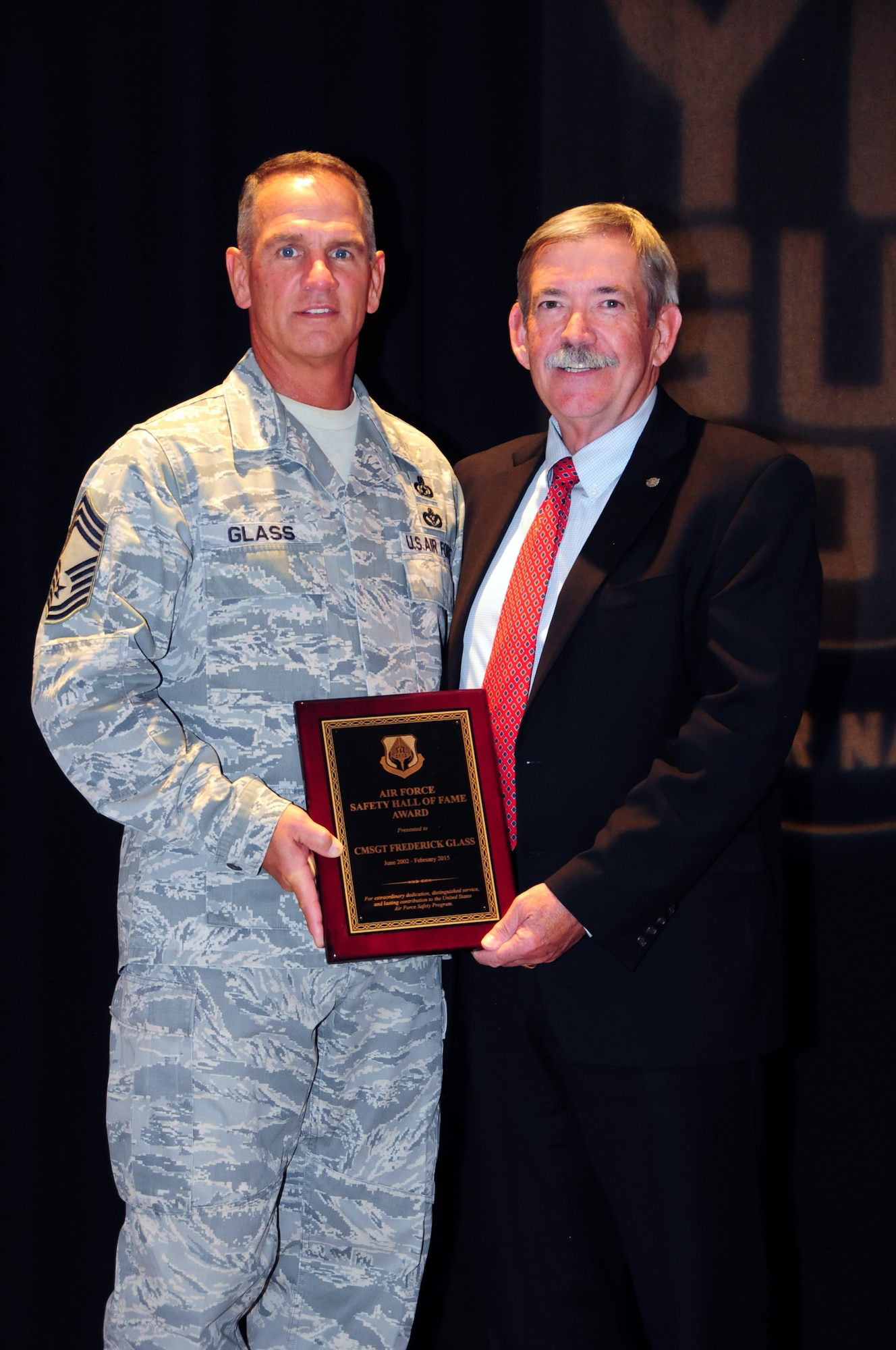 Chief Master Sgt. Frederick Glass, Air National Guard chief of occupational safety, stands with chief of Air Force ground safety, Bill Parsons, after being presented the Air Force Safety Hall of Fame Award at the Air National Guard Mishap Prevention Workshop held in Albuquerque, New Mexico, May 12, 2015. Glass is the first enlisted ANG member to receive the award since its inception in 1977. (U.S. Air National Guard photo by Master Sgt. Paula Aragon)