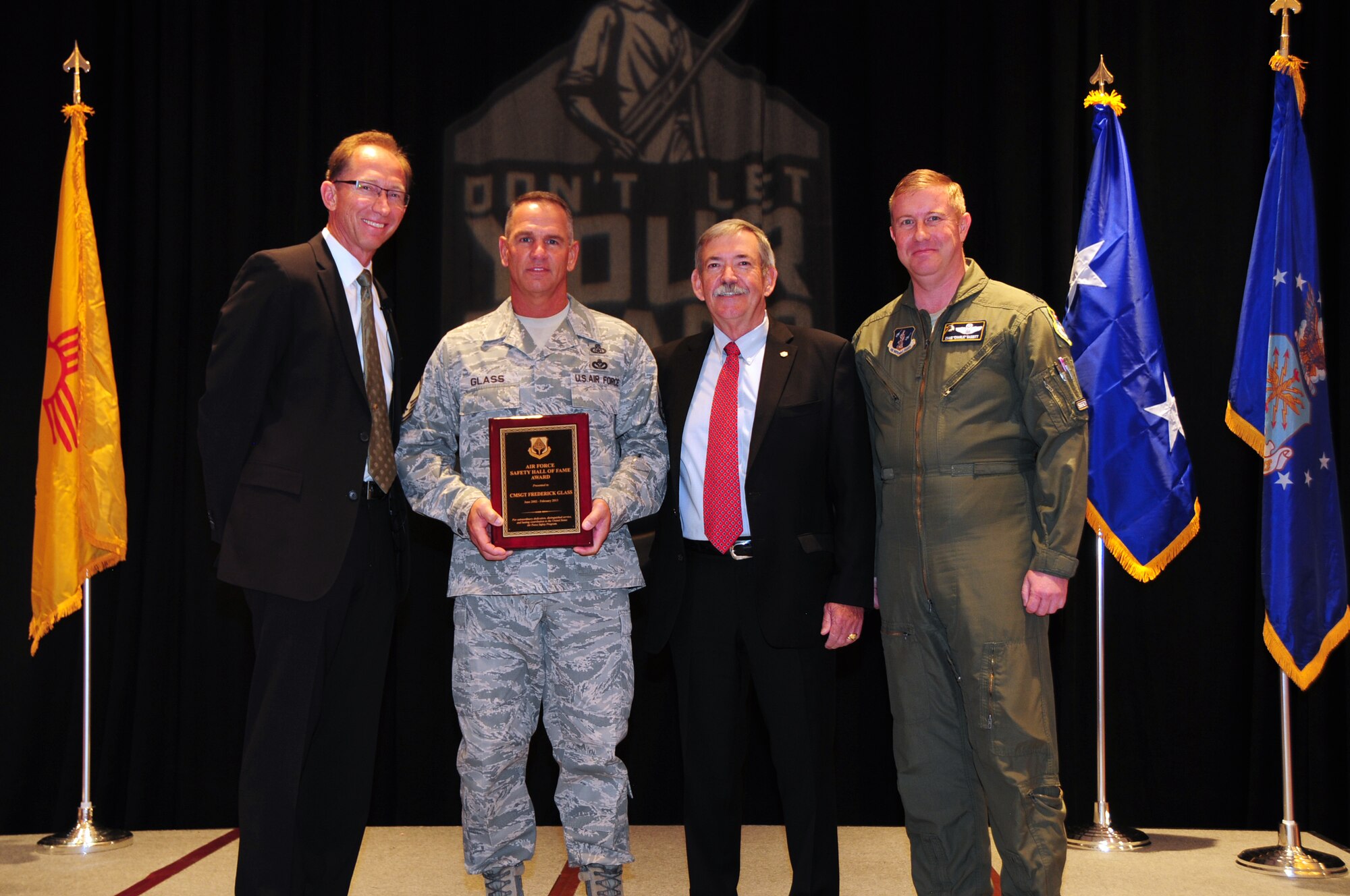 James Rubeor, Air Force Safety Center executive director; Bill Parsons, chief of Air Force ground safety; and Lt. Col. Craig Babbit, flight safety officer, present Chief Master Sgt. Frederick Glass, chief of Air National Guard occupational safety, the Air Force Safety Hall of Fame Award at the Albuquerque, New Mexico Mishap Prevention Workshop, May 12, 2015. Glass is the first enlisted ANG member to receive the award since its inception in 1977. (U.S. Air National Guard photo by Master Sgt. Paula Aragon)