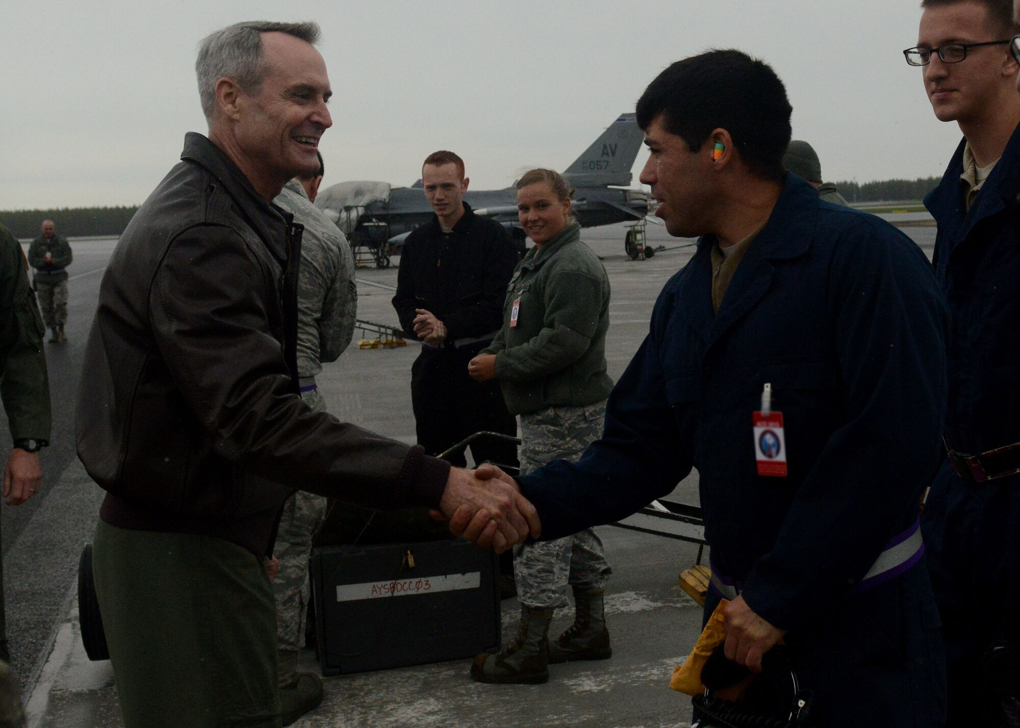 Lt. Gen. Darryl Roberson, 3rd Air Force and 17th Expeditionary Air Force commander, shakes hands with Staff Sgt. Travis Edelman, 31st Aircraft Maintenance Squadron crew chief, at Kallax Air Base, Sweden June 1, 2015.  Roberson thanked Airmen for their hard work during Arctic Challenge Exercise 2015.  During his visit, Roberson was briefed on the exercise, visited Airmen and observed mission takeoffs. (U.S. Air Force photo by Staff Sgt. Evelyn Chavez)