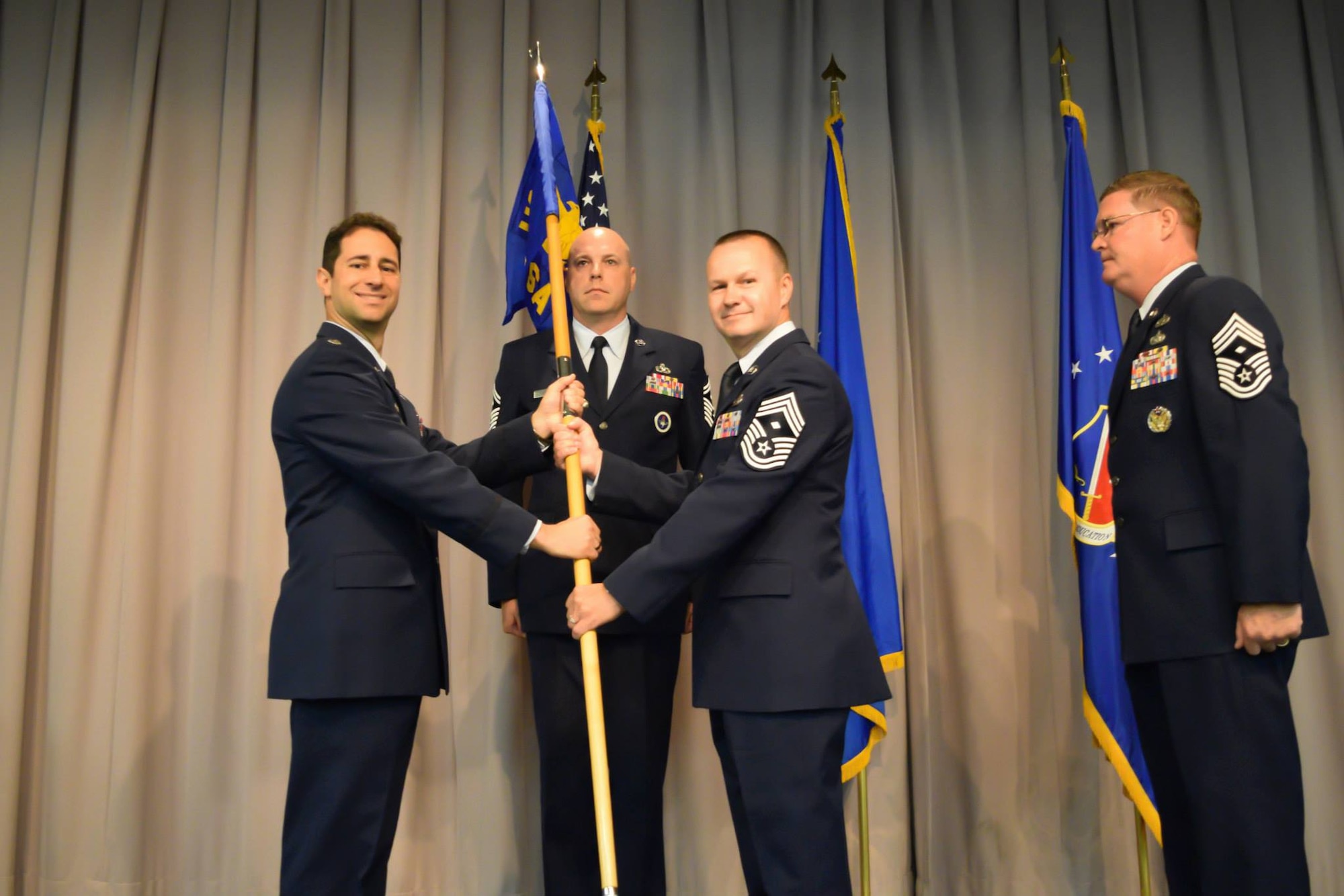 Chief Master Sgt. Danny R. Doucette receives the US Air Force First Sergeants' Academy guidon from Lt. Col. Michael J. Artelli, FSA commander, during a change of authority ceremony at Maxwell Air Force Base, Alabama, May 27, 2015. Doucette, who replaces Chief Master Sgt. Paul L. Hughes, is the first Air National Guard member to serve as the academy's commandant. (Courtesy Photo) 