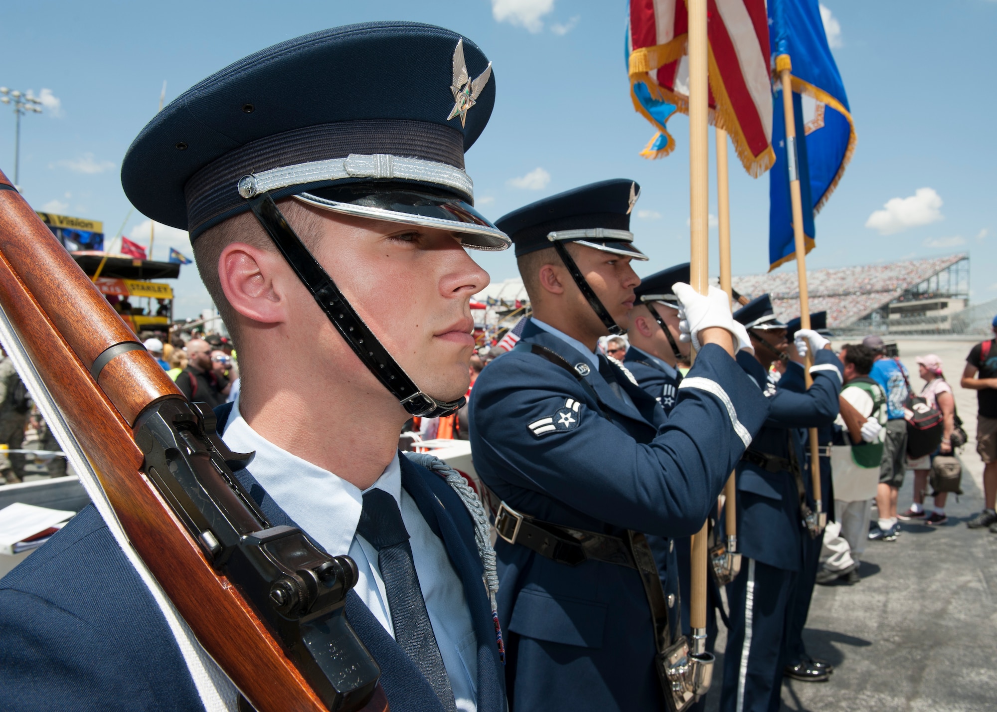 Senior Airman Jeremey Clemente, Dover Air Force Base Honor Guard, stands at attention prior to the start of the FedEx 400 Benefiting Autism Speaks NASCAR race May 31, 2015, at Dover International Speedway in Dover, Del. The Honor Guard presented colors during the singing of the national anthem. (U.S. Air Force photo/Airman 1st Class Zachary Cacicia)