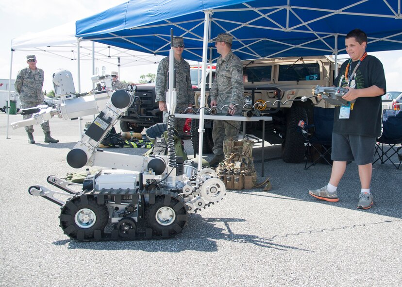 A NASCAR fan operates an Explosive Ordnance Disposal F6A robot May 30, 2015, at Dover International Speedway in Dover, Del. The EOD flight let NASCAR fans try on the EOD bot, bomb suit and allowed them to get inside of a M1165 Humvee that was set up inside of the Monster FunZone. (U.S. Air Force photo/Senior Airman Jared Duhon)