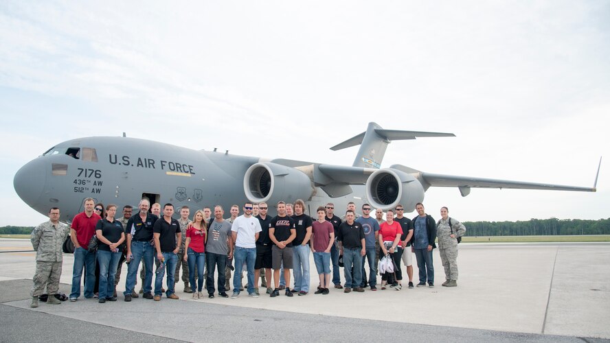 Crew members from BK Racing and MAKE Motorsports pose with members of Team Dover May 28, 2015, at Dover Air Force Base, Del. The NASCAR teams took an orientation flight on a C-17A Globemaster III which went on a mid-air refueling mission. (U.S. Air Force photo/Senior Airman Jared Duhon) 