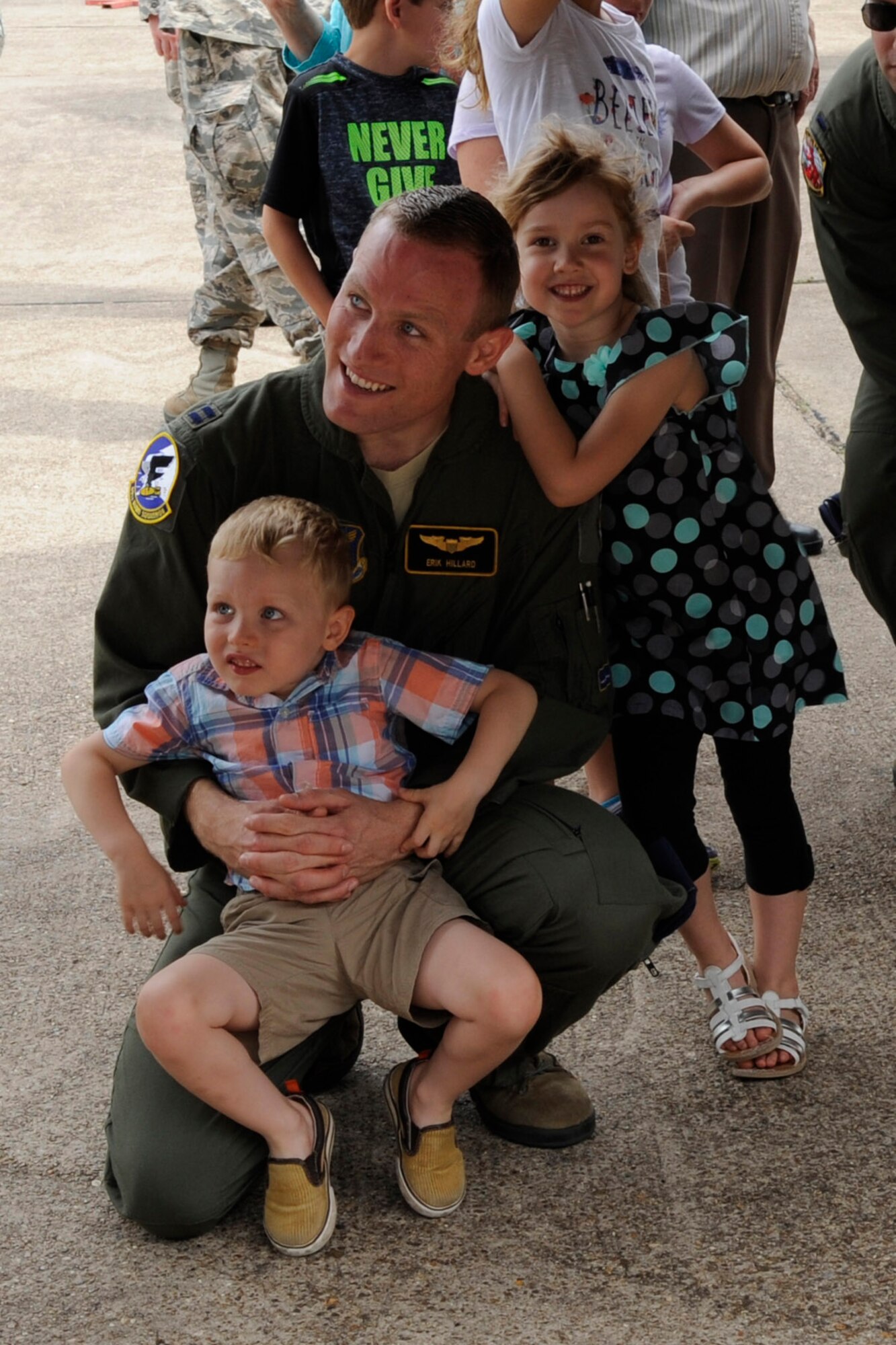 U.S. Air Force Capt. Eric Hillard, graduating Formal Training Unit Class 14-03, sits with his children while they wait in line to tour the flight deck of the B-52 at Barksdale Air Force Base, La on May 29, 2015. (U.S. Air Force photo by Master Sgt. Laura Siebert /Released)