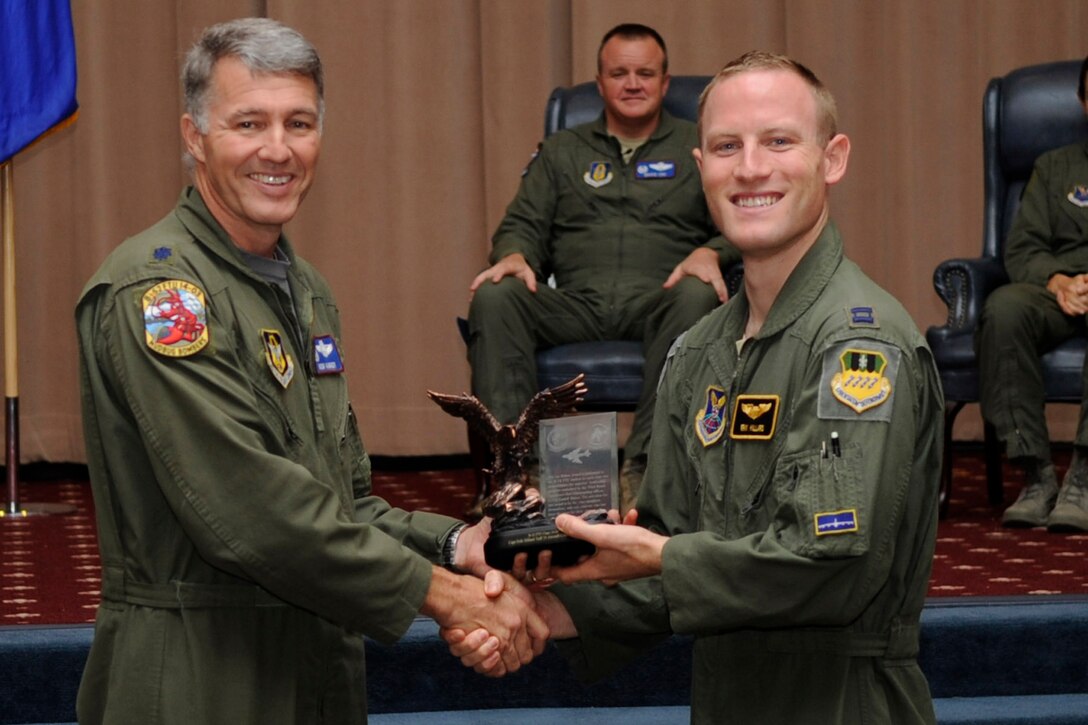 U.S. Air Force Lt. Col. Robert Van Hoy, 93rd Bomb Squadron commander, presents the Lindell Mabus Leadership Award to Capt. Eric Hillard during a Formal Training Unit graduation ceremony, May 29, 2015, Barksdale Air Force Base, La. Hillard was selected by his fellow class members for his exceptional leadership, which was critical to the class's graduation. (U.S. Air Force photo by Master Sgt. Laura Siebert /Released)