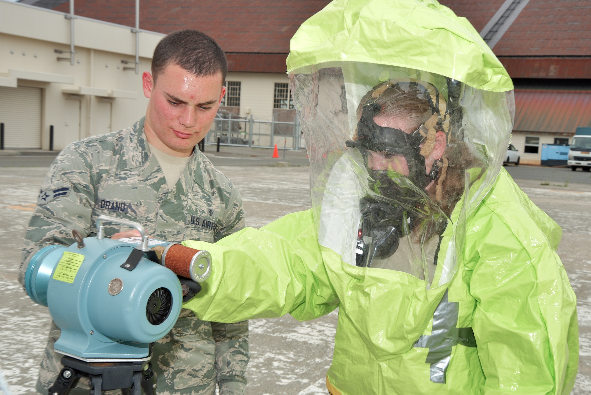 U.S. Air Force Airman 1st Class Petri Brand assists Airman 1st Class Ann Keyser, both Bioenvironmental Engineer Technicians assigned to the 35th Aerospace Medicine Squadron, in utilizing a RADēCO during training at Misawa Air Base, Japan, June, 2, 2015. The system, used to detect radiation levels, is only one piece of equipment in many the the BEEs train on for emergency response preparedness. (U.S. Air Force photo by Senior Airman Jose L. Hernandez-Domitilo/Released)