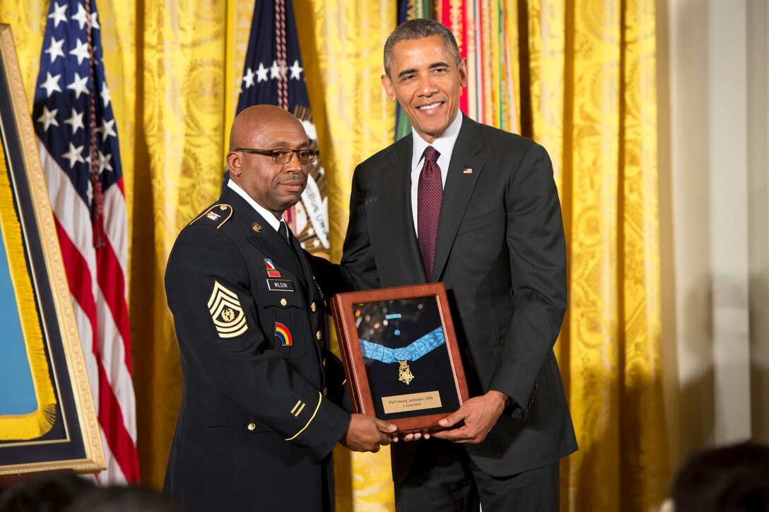 Army Command Sgt. Maj. Louis Wilson, New York National Guard senior enlisted advisor, accepts the Medal of Honor from President Barack Obama on behalf of Pvt. Henry Johnson, who served during World War I with the 369th Infantry Regiment, known as the Harlem Hellfighters, June 2, 2015, at the White House.