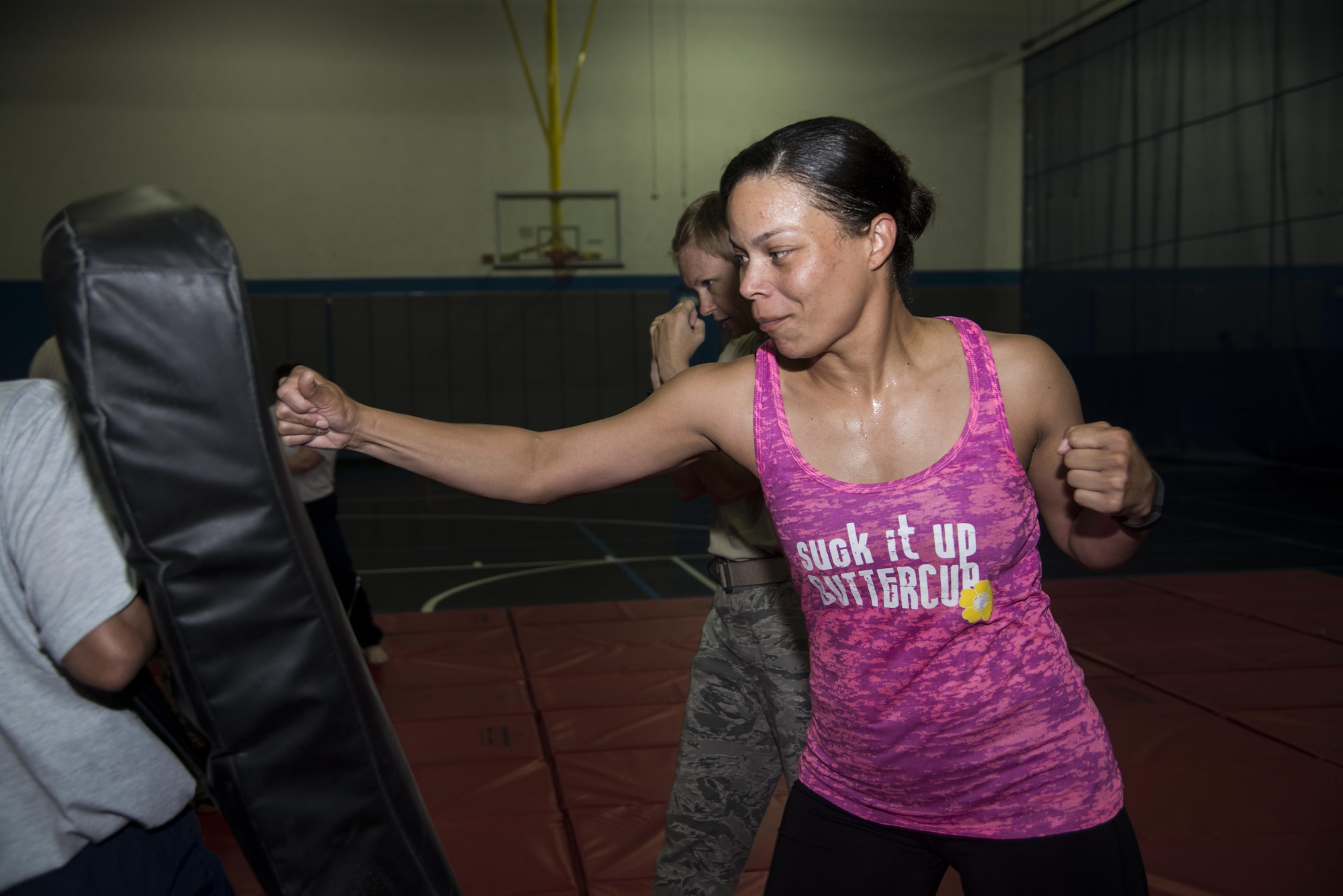 Tech. Sgt. Marquita Oliver, 379th Expeditionary Forces Support Squadron Blanchard-Preston Complex lodging operations non-commissioned officer in charge, positions herself to deliver a jab during a combatives class at the BPC gym May 29, 2015 at Al Udeid Air Base, Qatar. Bi-weekly, Airmen of the 379th Expeditionary Security Forces Squadron instruct members on non-lethal ways to defend themselves. (U.S. Air Force photo/Tech. Sgt. Rasheen Douglas)