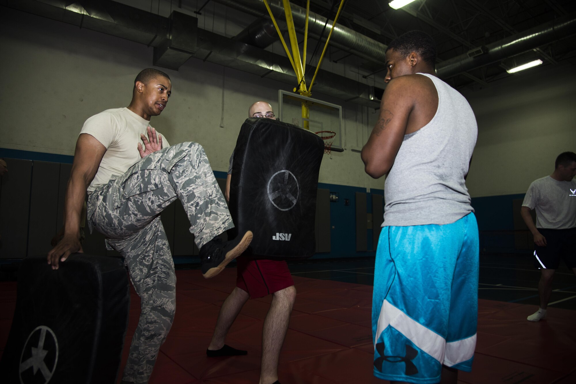 Staff Sgt. Jared Kimbrough, 379th Expeditionary Security Forces Check Six facilitator and training non-commissioned officer in charge, instructs proper technique on kicking during a combatives class at the Blanchard-Preston Complex gym May 29, 2015 at Al Udeid Air Base, Qatar. Bi-weekly, Airmen of the 379th Expeditionary Security Forces Squadron instruct members on non-lethal ways to defend themselves. (U.S. Air Force photo by Tech. Sgt. Rasheen Douglas)