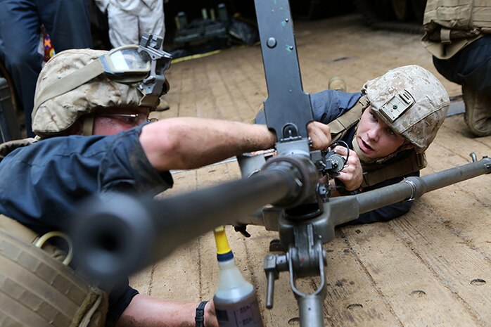 Lance Cpls. Jeremy Mackey, right, and Matthew Yeats, both Amphibious Assault Vehicle Crewman with Kilo Company, Battalion Landing Team 3rd Battalion, 6th Marine Regiment, 24th Marine Expeditionary Unit, conduct crew-served weapon drills on a .50-caliber machine gun aboard the amphibious dock landing ship USS Fort McHenry (LSD 43), March 30, 2015. The 24th MEU is embarked on the ships of the Iwo Jima Amphibious Ready Group and deployed to maintain regional security in the U.S. 5th Fleet area of operations.  (U.S. Marine Corps photo by Sgt. Devin Nichols)