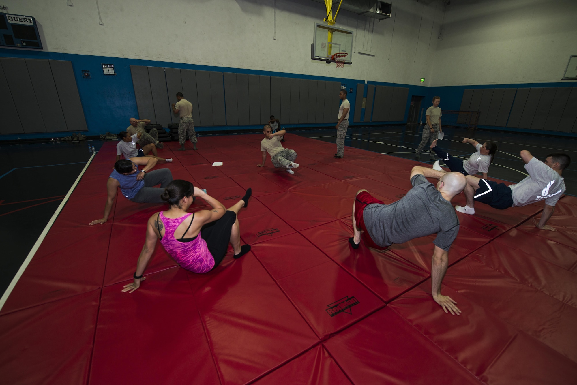 Airmen from 379th Expeditionary Security Forces Squadron instruct volunteers how to quickly put themselves back into a guarding position during a combatives class at the Blanchard-Preston Complex gym May 29, 2015 at Al Udeid Air Base, Qatar. Bi-weekly, members of the 379th Expeditionary Security Forces Squadron instruct members on non-lethal ways to defend themselves. (U.S. Air Force photo byTech. Sgt. Rasheen Douglas)