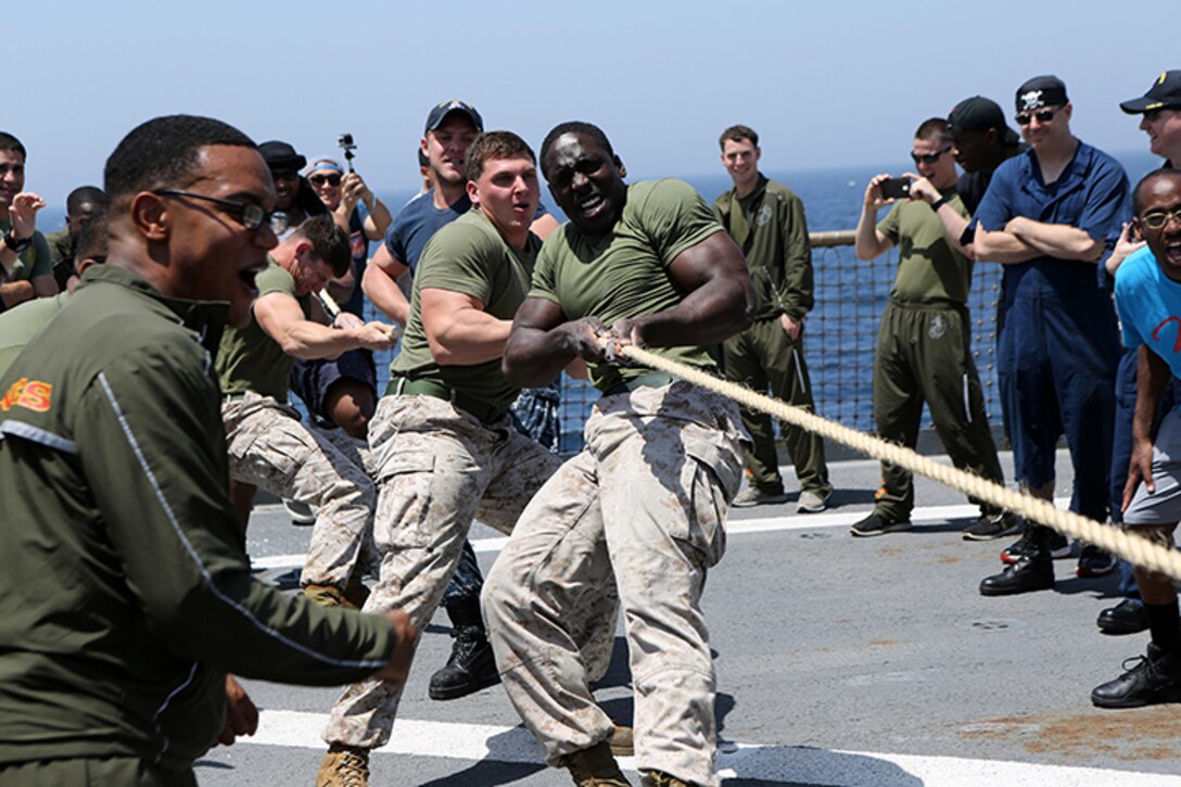Marines with Kilo Company, Battalion Landing Team 3rd Battalion, 6th Marine Regiment, 24th Marine Expeditionary Unit, participate in a tug-o-war contest during the “Halfway Block Party” aboard the amphibious dock landing ship USS Fort McHenry (LSD 43), April 2, 2015. The 24th MEU is embarked on the ships of the Iwo Jima Amphibious Ready Group and deployed to maintain regional security in the U.S. 5th Fleet area of operations.  (U.S. Marine Corps photo by Sgt. Devin Nichols)
