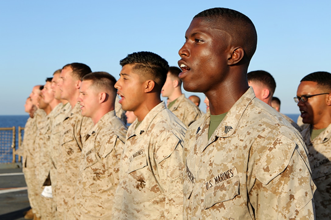 Marines with the 24th Marine Expeditionary Unit, sing the “Marines’ Hymn” during a Corporal’s Leadership Course graduation aboard the USS Fort McHenry (LSD 43), April 4, 2015. The 24th MEU is embarked on the ships of the Iwo Jima Amphibious Ready Group and deployed to maintain regional security in the U.S. 5th Fleet area of operations.  (U.S. Marine Corps photo by Sgt. Devin Nichols)