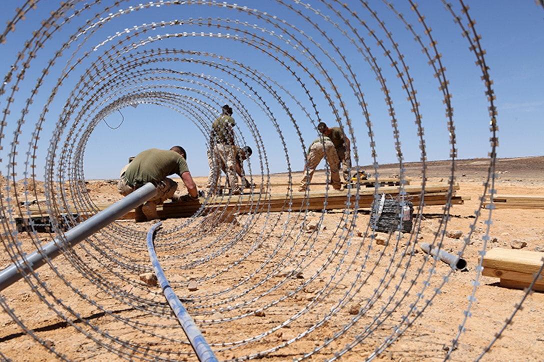 Combat engineers with Kilo Company, Battalion Landing Team 3rd Battalion, 6th Marine Regiment, 24th Marine Expeditionary Unit, hammer nails and cut wood pieces during Exercise Eager Lion 2015 at Wadi Al Shadiyah, Jordan, May 1, 2015. The 24th MEU is embarked on the ships of the Iwo Jima Amphibious Ready Group and deployed to maintain regional security in the U.S. 5th Fleet area of operations.  (U.S. Marine Corps photo by Sgt. Devin Nichols)