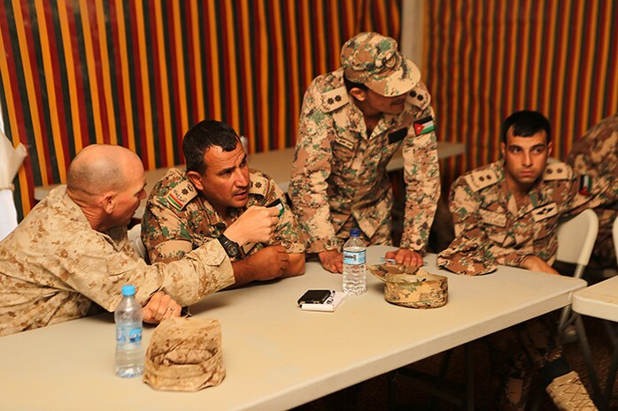 Major Eric Meador, left, the executive officer for Battalion Landing Team 3rd Battalion, 6th Marine Regiment, 24th Marine Expeditionary Unit, discusses exercise plans with Jordanian counterparts in preparation for Exercise Eager Lion 2015 in Jordan, May 3, 2015. Eager Lion is a recurring multinational exercise designed to strengthen military-to-military relationships, increase interoperability between partner nations, and enhance regional security and stability. The 24th MEU is embarked on the ships of the Iwo Jima Amphibious Ready Group and deployed to maintain regional security in the U.S. 5th Fleet area of operations. (U.S. Marine Corps photo by Sgt. Devin Nichols/Released)