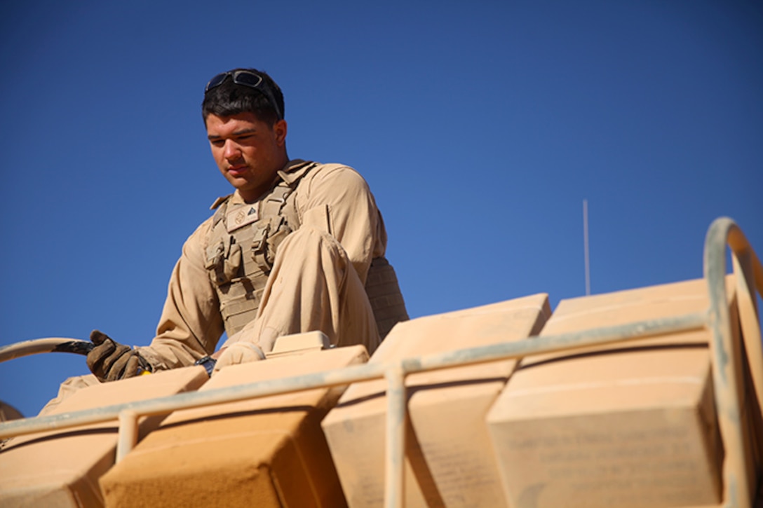 Cpl. Beau F. Zelenock, an amphibious assault vehicle (AAV) crew chief with Kilo Company, Battalion Landing Team 3rd Battalion, 6th Marine Regiment, 24th Marine Expeditionary Unit, refuels an AAV during Exercise Eager Lion at Wadi Al Shadiyah, Jordan, May 5, 2015. The 24th MEU is embarked on the ships of the Iwo Jima Amphibious Ready Group and deployed to maintain regional security in the U.S. 5th Fleet  area of operations. (U.S. Marine Corps photo by Lance Cpl. Austin A. Lewis)