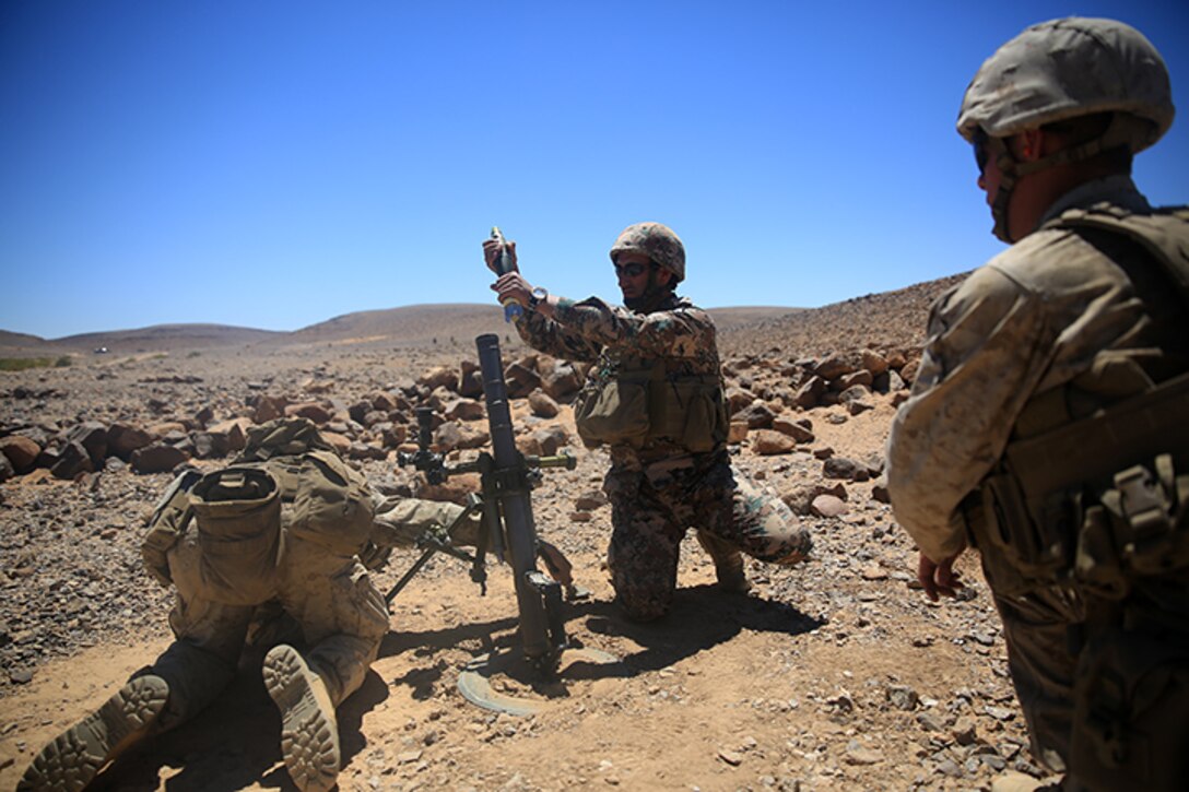 150505-M-WA276-186: JORDAN (May 5, 2015) Marines with Kilo Company, Battalion Landing Team 3rd Battalion, 6th Marine Regiment, 24th Marine Expeditionary Unit, and a Jordanian soldier, center, prepare to fire an M224A1 60 mm mortar during a bilateral live-fire exercise as part of Exercise Eager Lion 2015 in Jordan, May 5, 2015. Eager Lion is a recurring multinational exercise designed to strengthen military-to-military relationships, between partner nations and enhance regional security and stability. The 24th MEU is embarked on the ships of the Iwo Jima Amphibious Ready Group and deployed to maintain regional security in the U.S. 5th Fleet area of operations. (U.S. Marine Corps photo by Lance Cpl. Dani A. Zunun/Released)