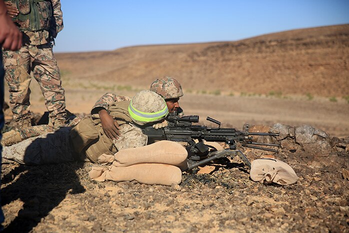 150505-M-WA276-250: JORDAN (May 5, 2015) A Marine with Kilo Company, Battalion Landing Team 3rd Battalion, 6th Marine Regiment, 24th Marine Expeditionary Unit, and a Jordanian soldier team up to employ an M249 Squad Automatic Weapon during bilateral live-fire training as part of Exercise Eager Lion 2015 in Jordan, May 5, 2015. Eager Lion is a recurring multinational exercise designed to strengthen military-to-military relationships, between partner nations and enhance regional security and stability. The 24th MEU is embarked on the ships of the Iwo Jima Amphibious Ready Group and deployed to maintain regional security in the U.S. 5th Fleet area of operations. (U.S. Marine Corps photo by Lance Cpl. Dani A. Zunun/Released)