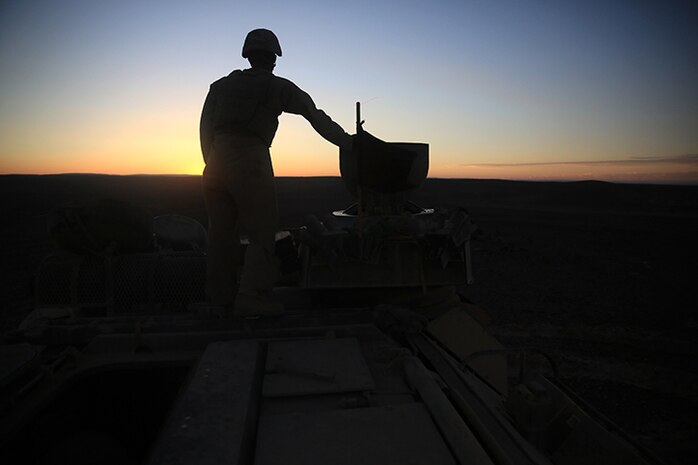 150506-M-WA276-429:JORDAN (May 6, 2015) Corporal Johann Carstensen, an assault amphibian crew chief, with Kilo Company, Battalion Landing Team 3rd Battalion, 6th Marine Regiment, 24th Marine Expeditionary Unit, observes 40 mm impacts during a live-fire exercise as part of Exercise Eager Lion 2015 in Jordan, May 6, 2015. Eager Lion is a recurring multinational exercise designed to strengthen military-to-military relationships, between partner nations and enhance regional security and stability. The 24th MEU is embarked on the ships of the Iwo Jima Amphibious Ready Group and deployed to maintain regional security in the U.S. 5th Fleet area of operations. (U.S. Marine Corps photo by Lance Cpl. Dani A. Zunun/Released)
