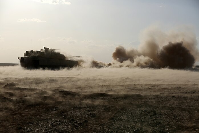 An M1A1 Abrams Main Battle Tank with Kilo Company, Battalion Landing Team 3rd Battalion, 6th Marine Regiment, 24th Marine Expeditionary Unit, fires its 120 mm smoothbore cannon during a live-fire event as part of Exercise Eager Lion 2015 in Jordan, May 9, 2015. Eager Lion is a recurring multinational exercise designed to strengthen military-to-military relationships, increase interoperability between partner nations, and enhance regional security and stability. The 24th MEU is embarked on the ships of the Iwo Jima Amphibious Ready Group and deployed to maintain regional security in the U.S. 5th Fleet area of operations. (U.S. Marine Corps photo by Sgt. Devin Nichols)