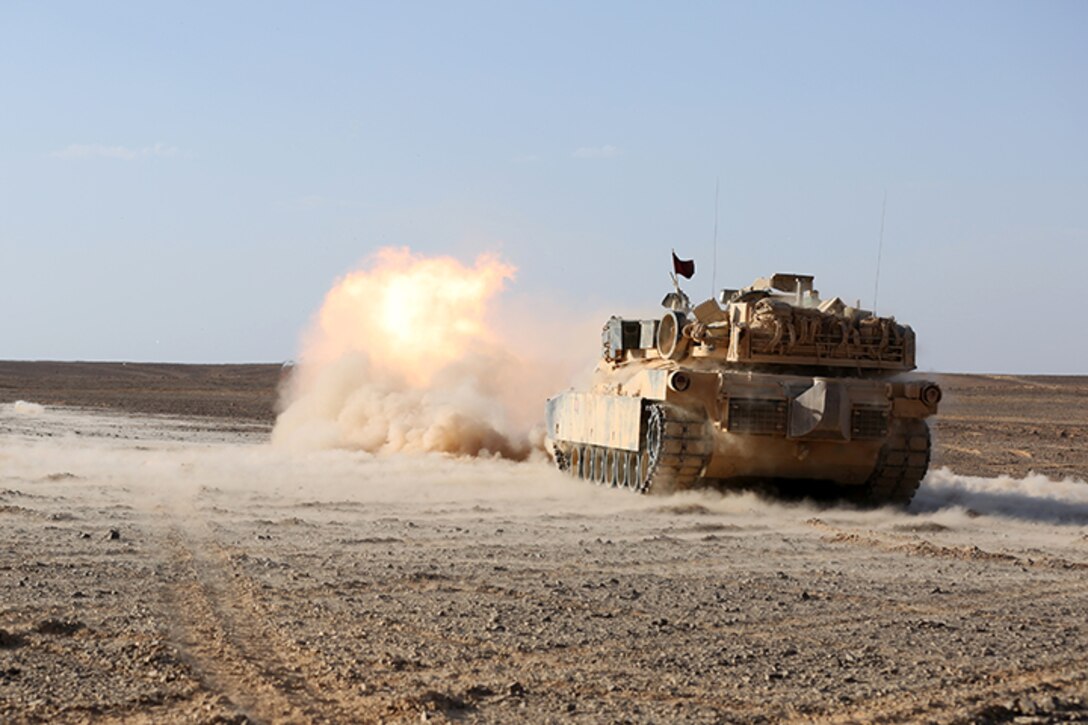 An M1A1 Abrams Main Battle Tank with Kilo Company, Battalion Landing Team 3rd Battalion, 6th Marine Regiment, 24th Marine Expeditionary Unit, fires its 120 mm smoothbore cannon during a live-fire event as part of Exercise Eager Lion 2015 in Jordan, May 9, 2015. Eager Lion is a recurring multinational exercise designed to strengthen military-to-military relationships, increase interoperability between partner nations, and enhance regional security and stability. The 24th MEU is embarked on the ships of the Iwo Jima Amphibious Ready Group and deployed to maintain regional security in the U.S. 5th Fleet area of operations. (U.S. Marine Corps photo by Sgt. Devin Nichols)