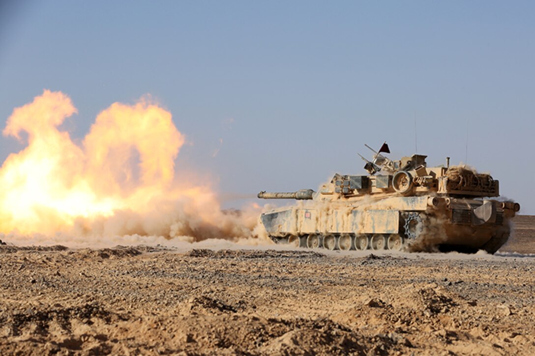 An M1A1 Abrams Main Battle Tank with Kilo Company, Battalion Landing Team 3rd Battalion, 6th Marine Regiment, 24th Marine Expeditionary Unit, fires its 120 mm smoothbore cannon during a live-fire event as part of Exercise Eager Lion 2015 in Jordan, May 9, 2015. Eager Lion is a recurring multinational exercise designed to strengthen military-to-military relationships, increase interoperability between partner nations, and enhance regional security and stability. The 24th MEU is embarked on the ships of the Iwo Jima Amphibious Ready Group and deployed to maintain regional security in the U.S. 5th Fleet area of operations. (U.S. Marine Corps photo by Sgt. Devin Nichols)