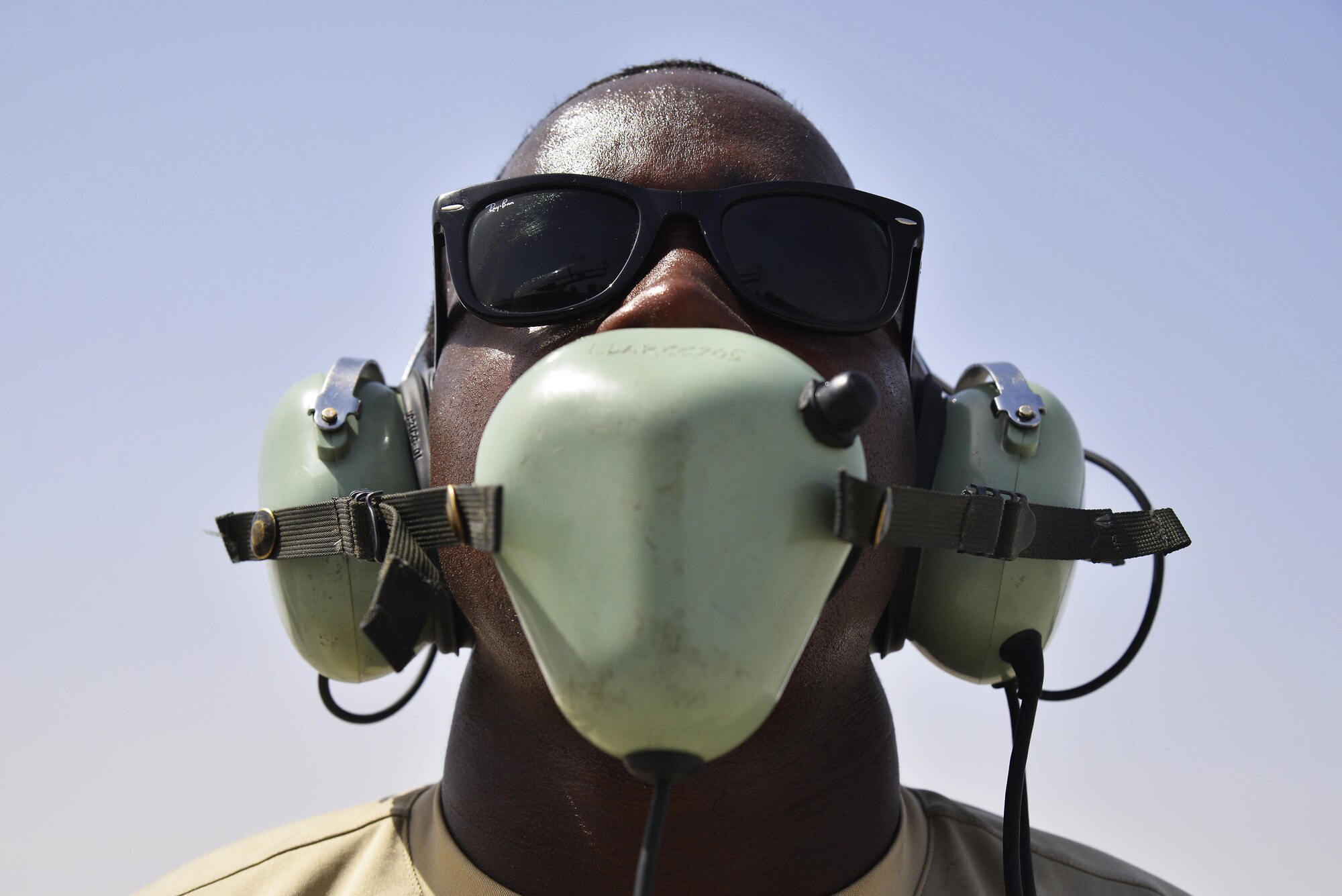 Staff Sgt. Oren communicates with F-15E Strike Eagle aircrew members during launching procedures at an undisclosed location in Southwest Asia May 31, 2015. Sgt. Oren is a dedicated crew chief assigned to the 380th Expeditionary Aircraft Maintenance Squadron. (U.S. Air Force photo/Tech. Sgt. Christopher Boitz) 