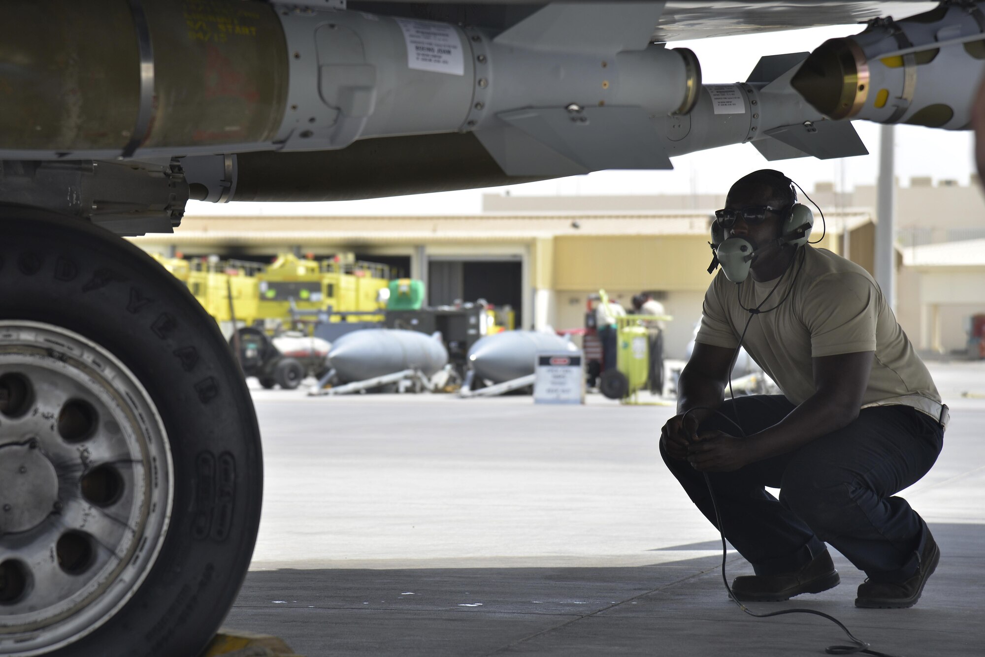 Staff Sgt. Oren performs a visual inspection underneath an F-15E Strike Eagle for hydraulic and gas leaks during launching procedures at an undisclosed location in Southwest Asia May 31, 2015. Sgt. Oren is a dedicated crew chief assigned to the 380th Expeditionary Aircraft Maintenance Squadron. (U.S. Air Force photo/Tech. Sgt. Christopher Boitz) 