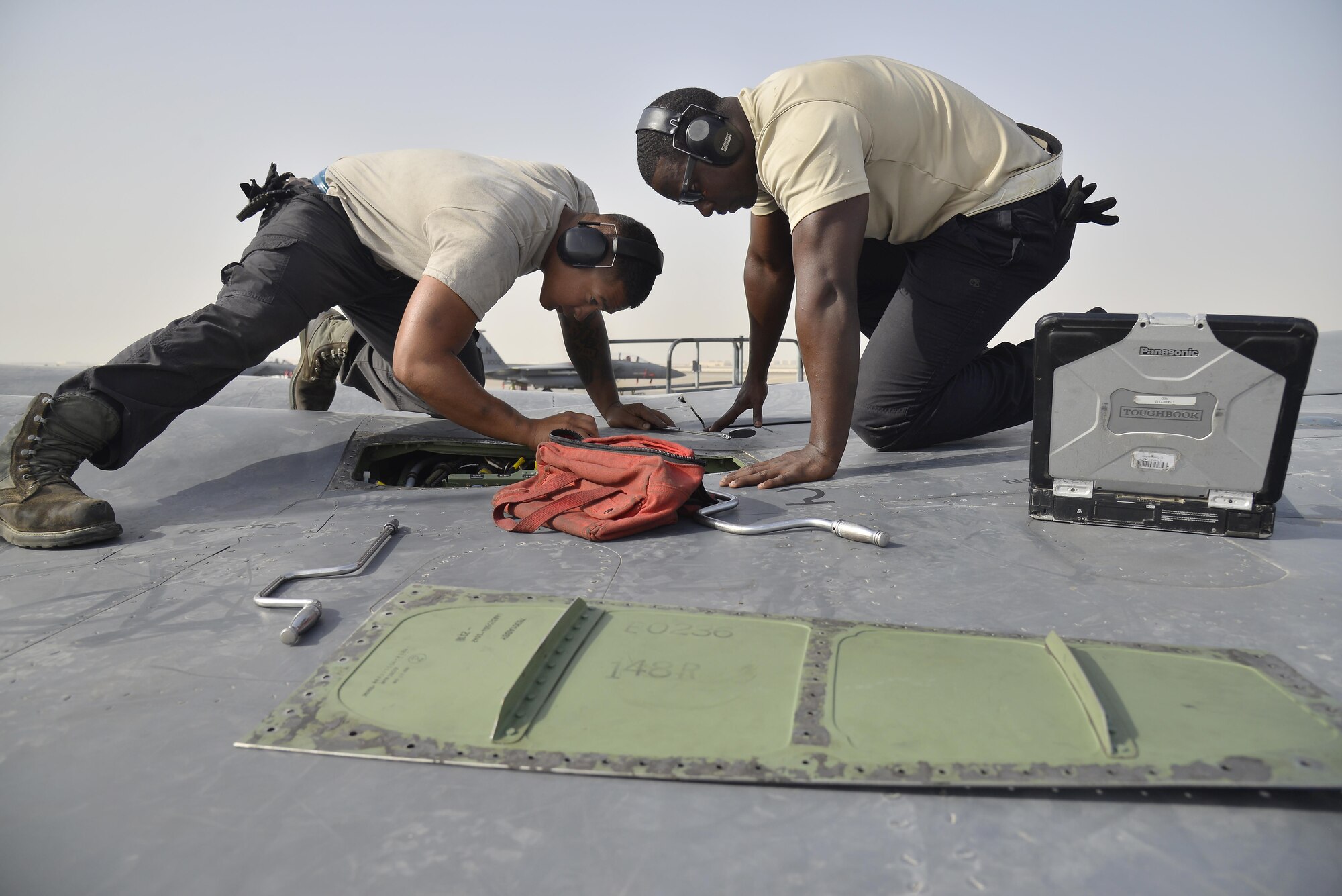 Senior Airman Isaiah, left, and Staff Sgt. Oren, right, perform a leak and operations check on an emergency generator inside an F-15E Strike Eagle at an undisclosed location in Southwest Asia May 31, 2015. Airman Isaiah and Sgt. Oren are dedicated crew chiefs assigned to the 380th Expeditionary Aircraft Maintenance Squadron. (U.S. Air Force photo/Tech. Sgt. Christopher Boitz) 