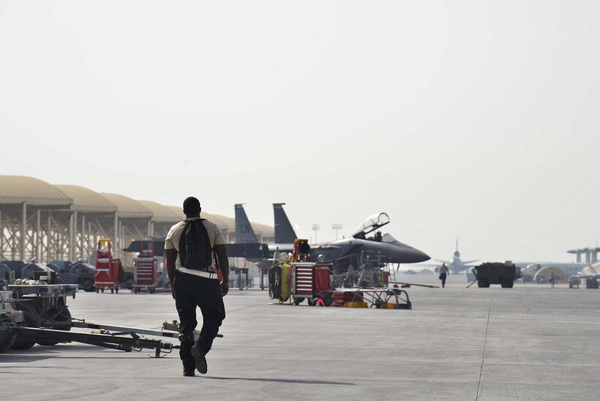 Staff Sgt. Oren walks the flightline during his shift at an undisclosed location in Southwest Asia June 2, 2015. Sgt. Oren is a dedicated crew chief assigned to the 380th Expeditionary Aircraft Maintenance Squadron. (U.S. Air Force photo/Tech. Sgt. Christopher Boitz) 