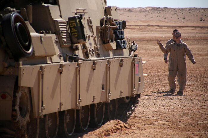 Sergeant Cody L. Olson, a main battle tank technician with the 24th Marine Expeditionary Unit’s Logistics Combat Element, Combat Logistics Battalion 24, guides an M88A2 Hercules Recovery Vehicle during Exercise Iron Magic outside of Al Hamra Military Base at United Arab Emirates, Feb. 7, 2015. (U.S. Marine Corps photo by Sgt. Devin Nichols)