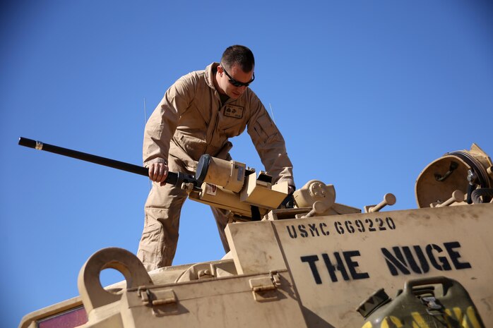 Sergeant Cody L. Olson, a main battle tank technician with the 24th Marine Expeditionary Unit’s Logistics Combat Element, Combat Logistics Battalion 24, assembles the .50 Caliber machine gun on the turret of an M88A2 Hercules Recovery Vehicle during Exercise Iron Magic outside of Al Hamra Military Base at United Arab Emirates, Feb. 7, 2015. (U.S. Marine Corps photo by Sgt. Devin Nichols)