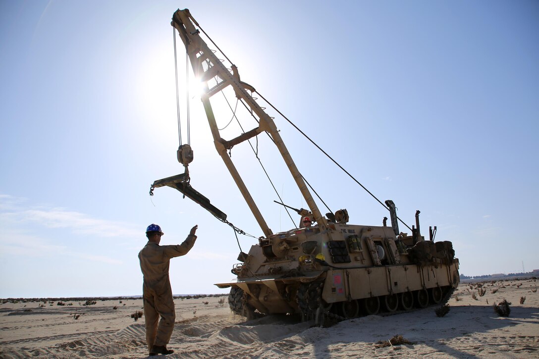 Sergeant Cody L. Olson, a main battle tank technician with the 24th Marine Expeditionary Unit’s Logistics Combat Element, Combat Logistics Battalion 24, guides an M88A2 Hercules Recovery Vehicle during Exercise Iron Magic outside of Al Hamra Military Base at United Arab Emirates, Feb. 8, 2015. (U.S. Marine Corps photo by Sgt. Devin Nichols)