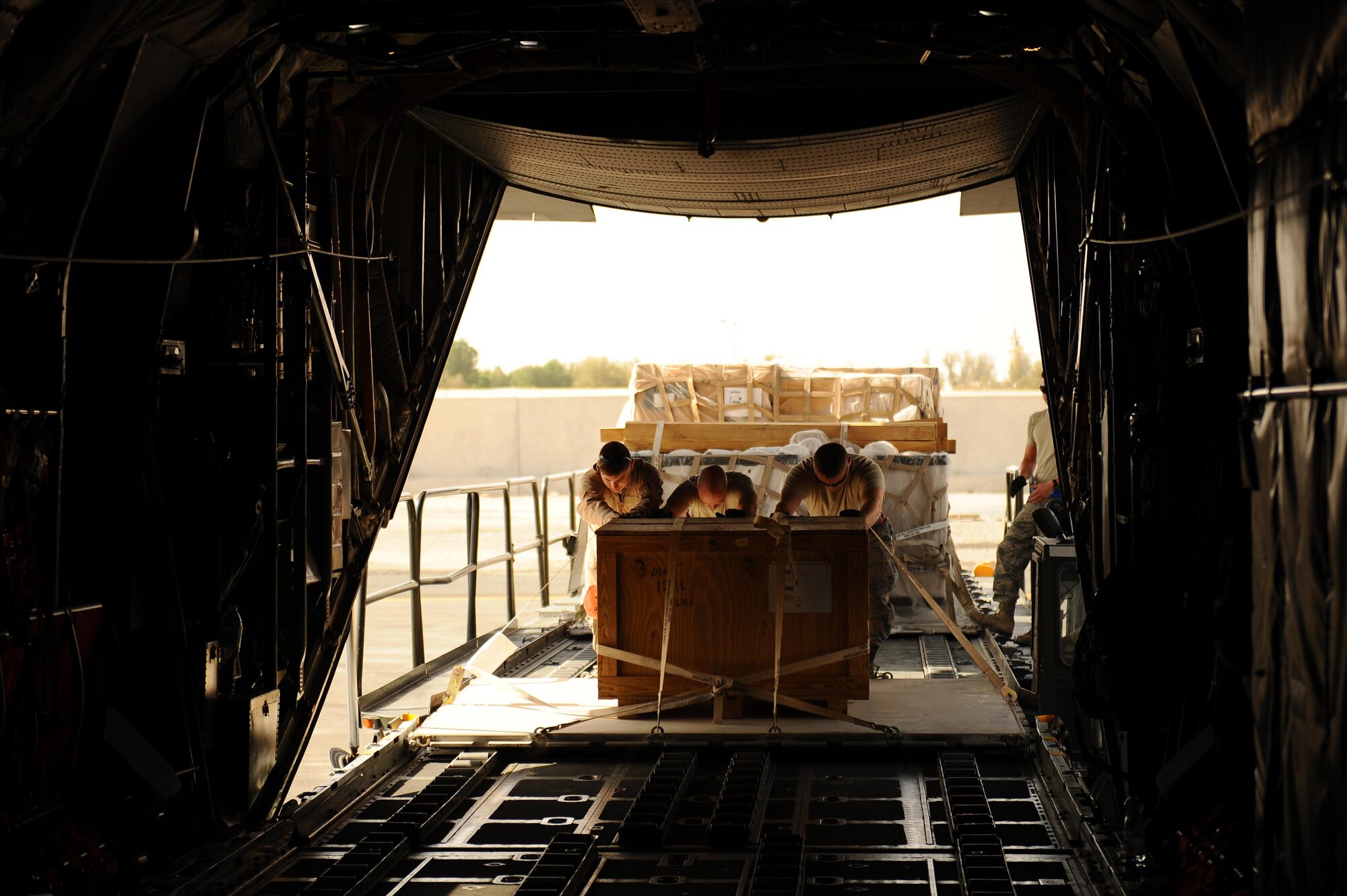 U.S. Air Force loadmasters of the 737th Expeditionary Airlift Squadron, deployed from the 911th Airlift Wing out of Pittsburgh Pa., load 12 thousand pounds of humanitarian and general supplies onto a C-130H Hercules aircraft in temperatures topping 118 degrees, June 1, 2015, at an undisclosed location in Southwest Asia. The aircrew delivered the supplies into Iraq in support of Operation Inherent Resolve. (U.S. Air Force photo/Tech. Sgt. Brittany E. Jones)