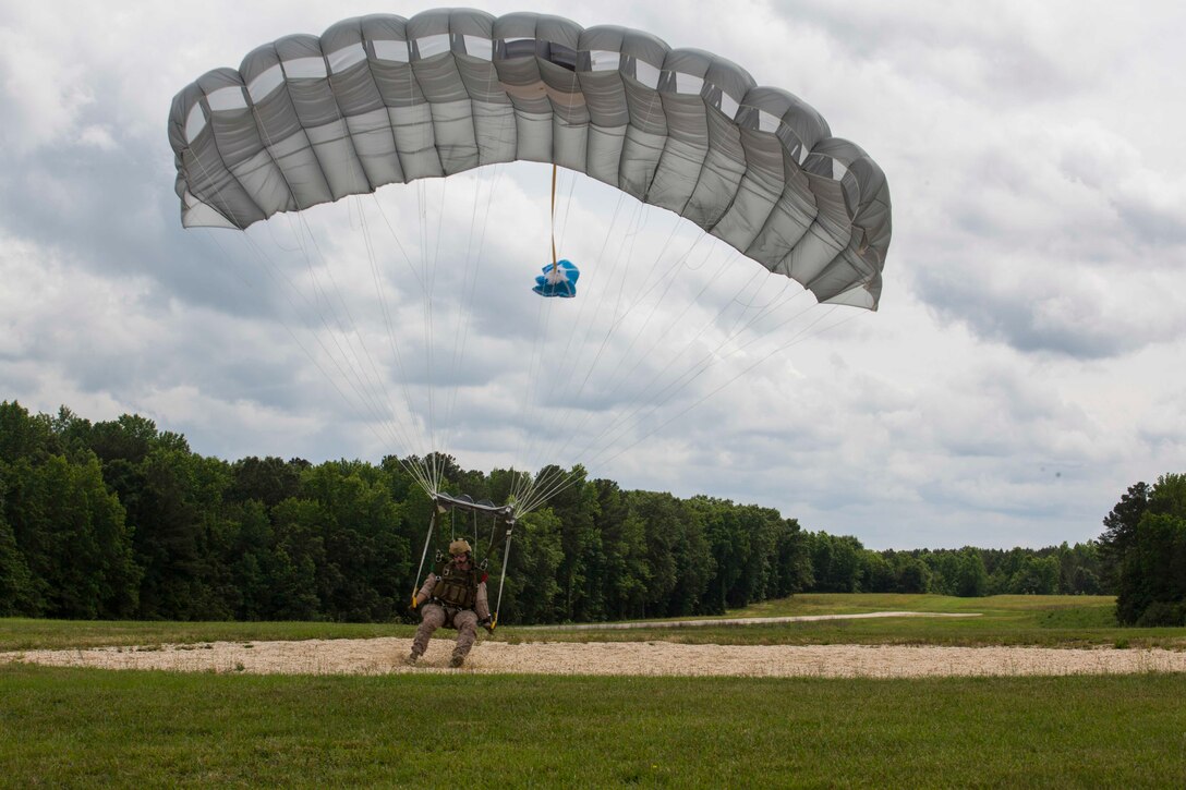 A U.S. Marine assigned to Force Reconnaissance Platoon, Maritime Raid Force, 26th Marine Expeditionary Unit (MEU), lands on his marked location after succesfully conducting a high altitude low opening (HALO) jump during category 3 sustainment training in Louisburg, N.C., June 2, 2015. The training allowed the Marines to practice proper techniques and procedures while in preparation for deployment to the 5th and 6th Fleet area of responsibility later this year. (U.S. Marine Corps photo by Cpl. Andre Dakis/26th MEU Combat Camera/Released)