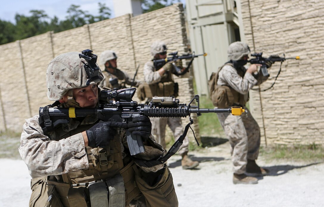 Marines with Company E, Battalion Landing Team 2/6 conduct military operations in urban terrain (MOUT) training at Mobile MOUT aboard Marine Corps Base Camp Lejeune, N.C., May 28, 2015. During the training, the Marines practiced patrolling, established vehicle checkpoints, and conducted assault drills during day and night operations. (Photo by Staff Sgt. Bobby J. Yarbrough)