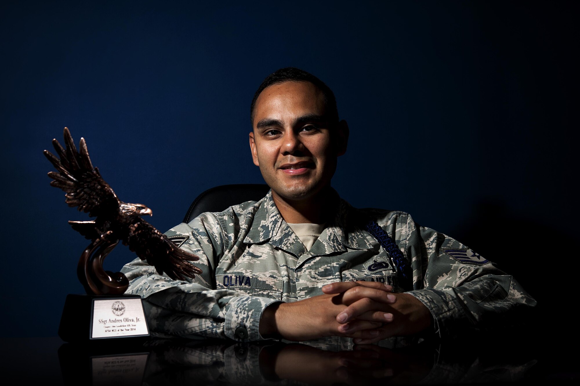 U.S. Air Force Tech. Sgt. Andres N. Oliva Jr., 316th Training Squadron military training leader, poses with the Air Force Sergeant Association NCO of the Year award at the 316th TRS dormitories on Goodfellow Air Force Base, Texas, May 6, 2015. Oliva won the award for the division four category, a chapter spanning from Texas to Mississippi. (U.S. Air Force photo by Senior Airman Scott Jackson/Released)